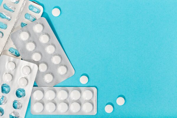 Medicine pills on blue background