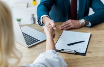 selective focus of employee and recruiter shaking hands