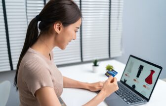 Asian young woman use laptop computer for shopping product sell online.